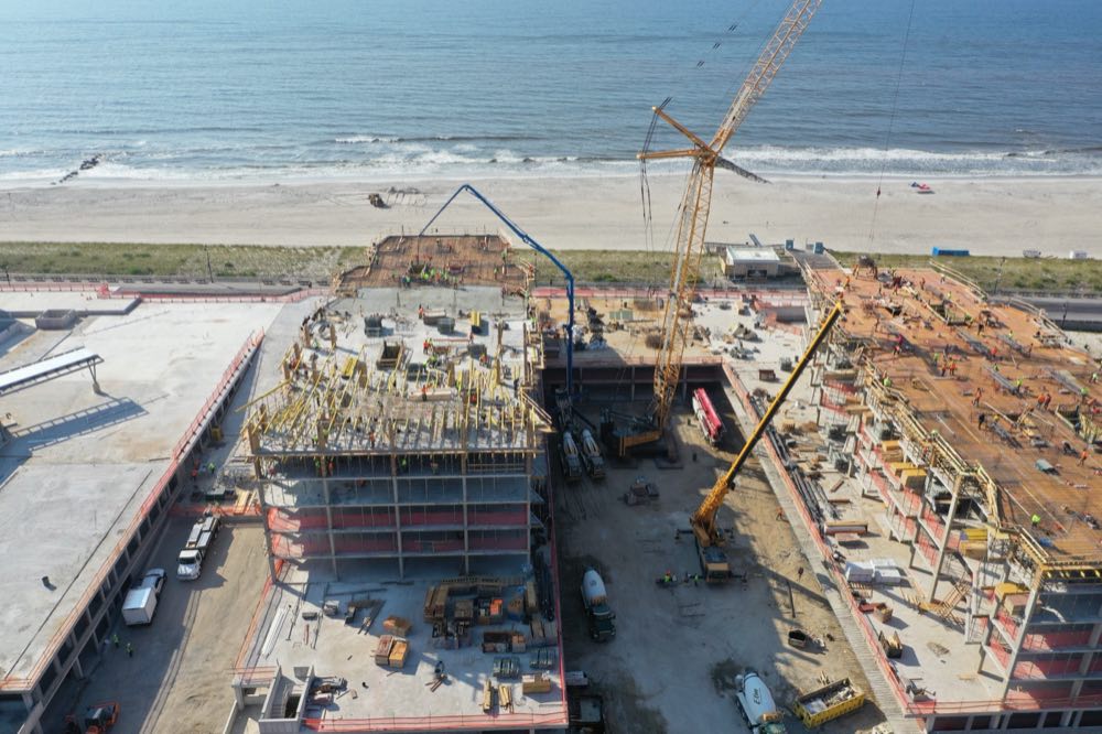 Aerial view of a large oceanfront concrete building project under construction